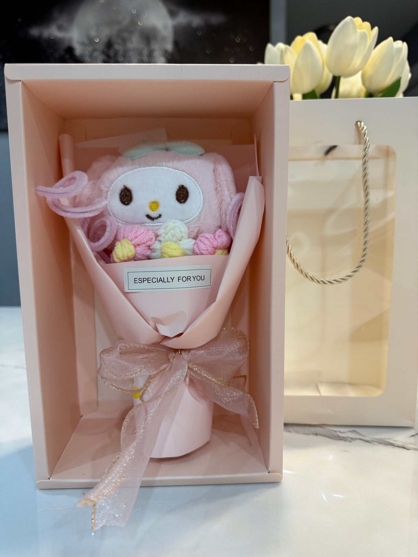 Mini bouquet of flowers with a plush toy.